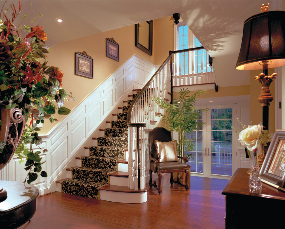 This is an example of a mid-sized traditional foyer in Philadelphia with yellow walls and medium hardwood floors.
