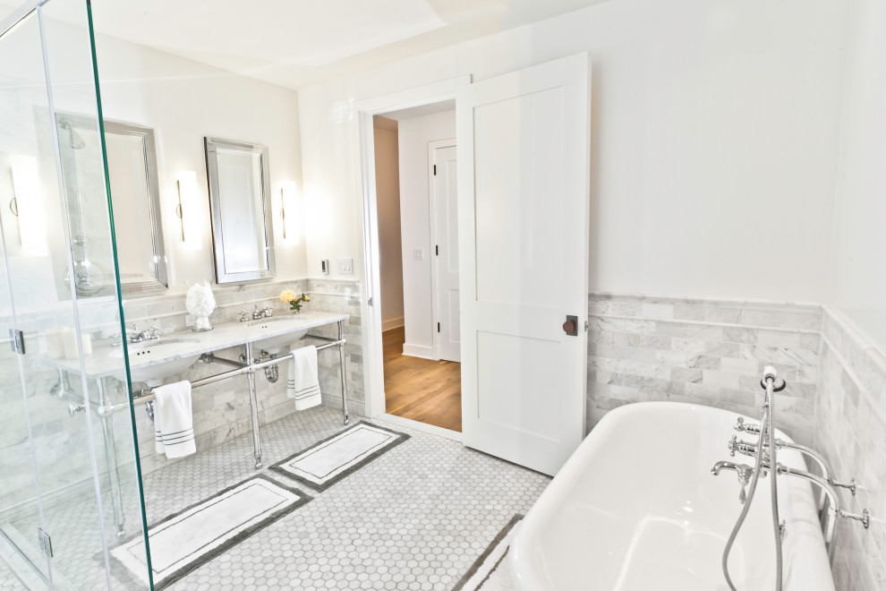 Inspiration for a large industrial master bathroom in New York with open cabinets, a freestanding tub, a corner shower, a one-piece toilet, gray tile, marble, white walls, marble floors, a pedestal sink, marble benchtops, grey floor, a hinged shower door and grey benchtops.