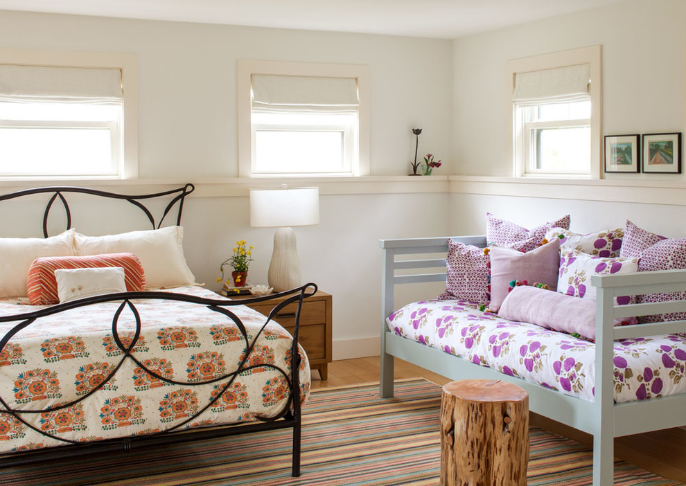 Photo of a beach style guest bedroom in Boston with beige walls, medium hardwood floors and no fireplace.