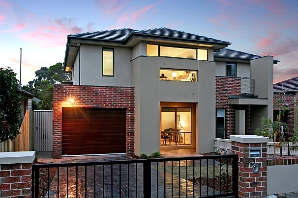 Photo of a traditional two-storey townhouse exterior in Melbourne with a hip roof and a tile roof.