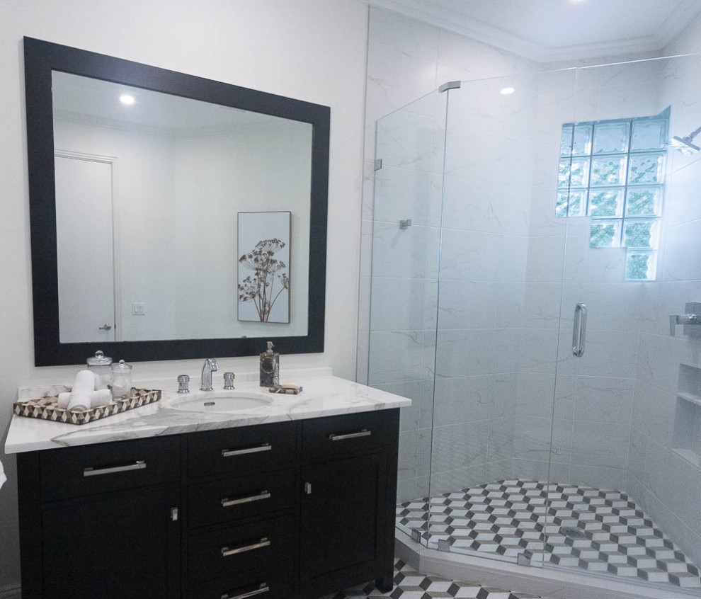 This is an example of a small contemporary bathroom in Miami with shaker cabinets, black cabinets, a corner shower, a one-piece toilet, white tile, porcelain tile, white walls, porcelain floors, an undermount sink, engineered quartz benchtops, a hinged shower door, white benchtops, a single vanity and a freestanding vanity.