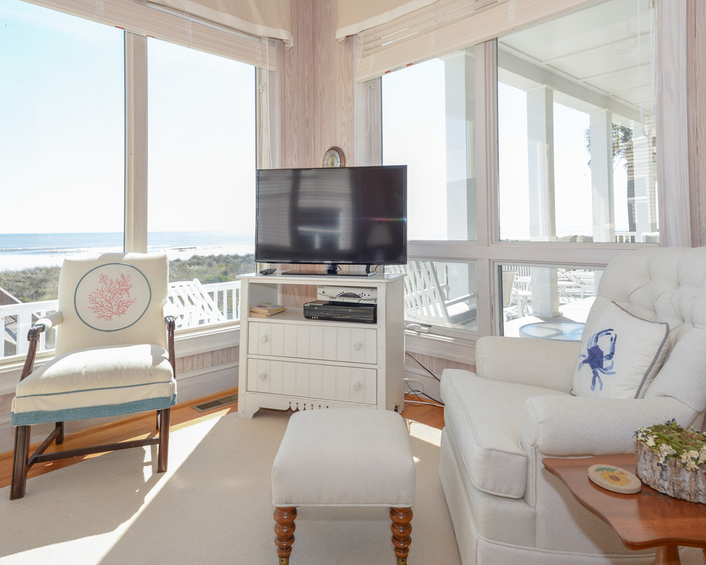 This is an example of a mid-sized beach style sunroom in Charleston with light hardwood floors and a standard ceiling.
