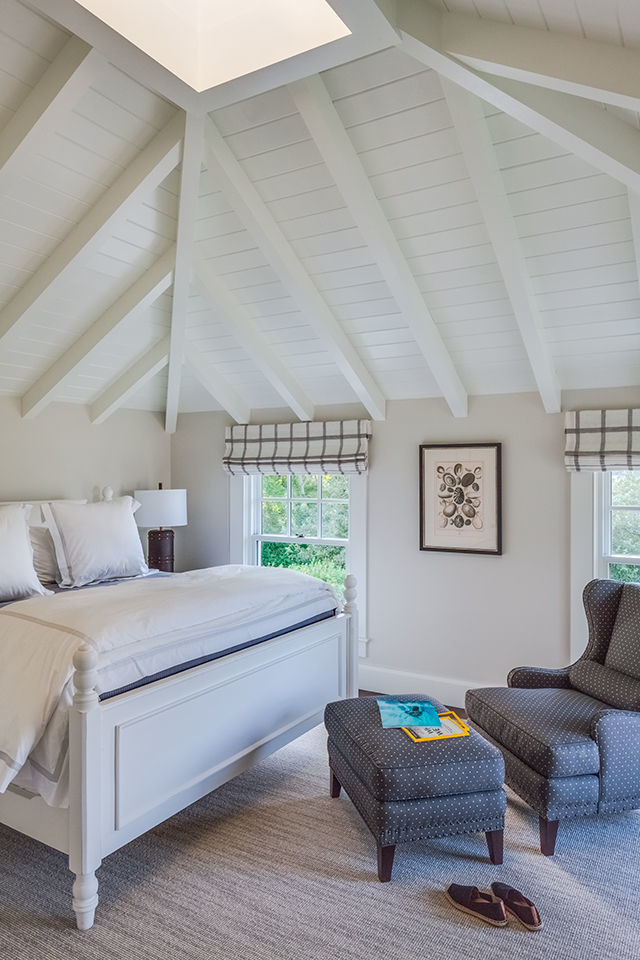 Photo of a small beach style guest bedroom in Boston with beige walls, carpet and grey floor.