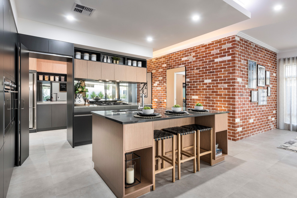 Mid-sized contemporary galley open plan kitchen in Perth with an undermount sink, flat-panel cabinets, black cabinets, solid surface benchtops, metallic splashback, mirror splashback, stainless steel appliances, ceramic floors, with island, grey floor and grey benchtop.