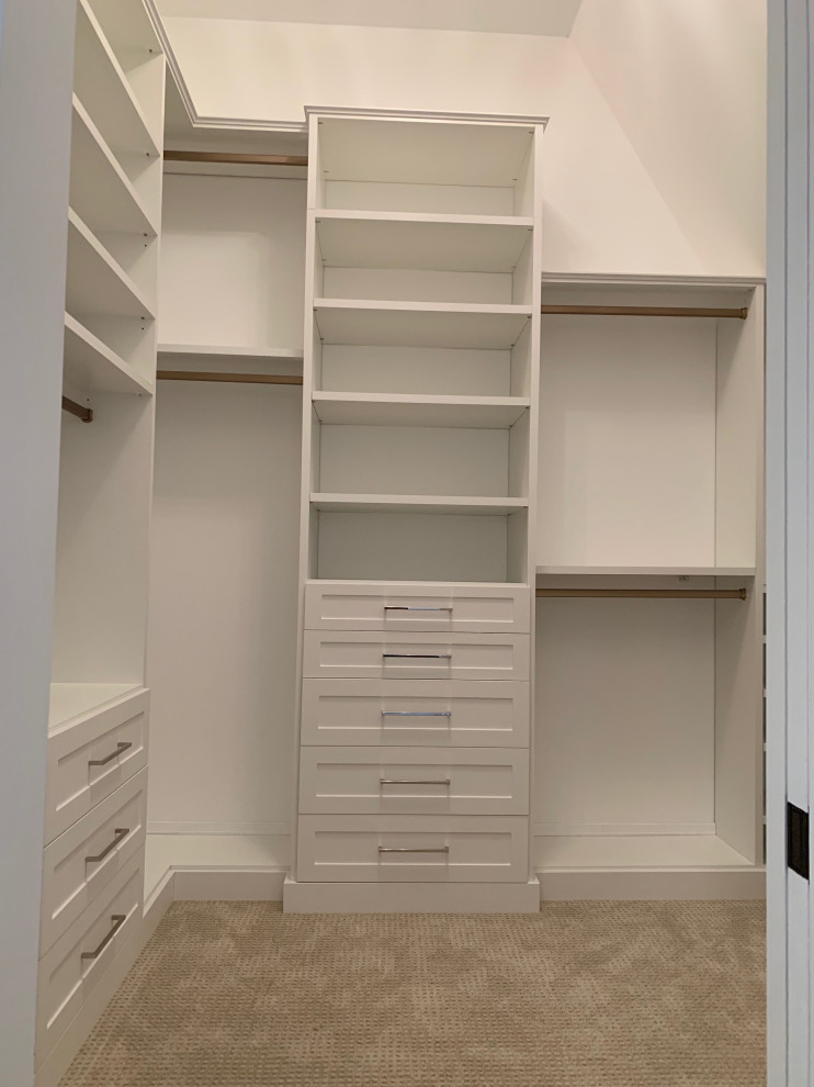 Photo of a mid-sized traditional walk-in wardrobe in Chicago with shaker cabinets, white cabinets, carpet and grey floor.