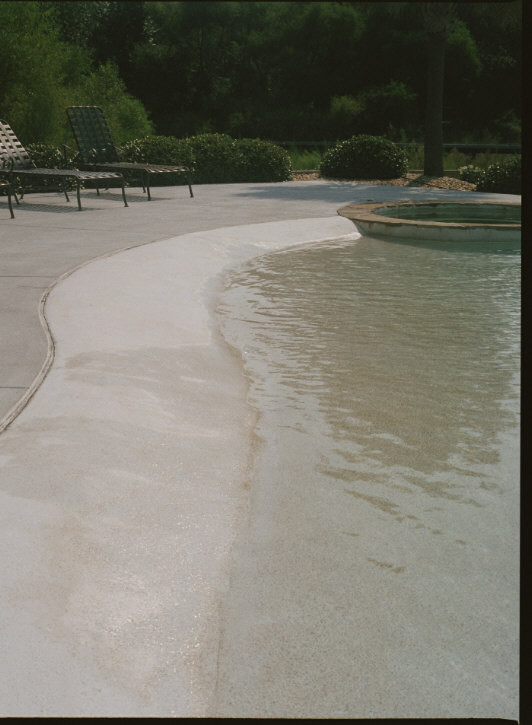 Inspiration for a large beach style backyard custom-shaped natural pool in Charlotte with a hot tub and concrete slab.