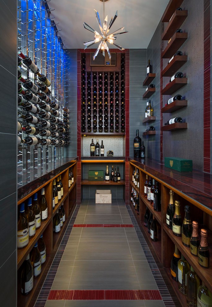 This is an example of a transitional wine cellar in Dallas with storage racks.