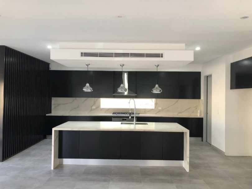 Large contemporary l-shaped kitchen/diner in Sydney with a submerged sink, all styles of cabinet, grey cabinets, engineered stone countertops, white splashback, marble splashback, stainless steel appliances, bamboo flooring, an island and white worktops.