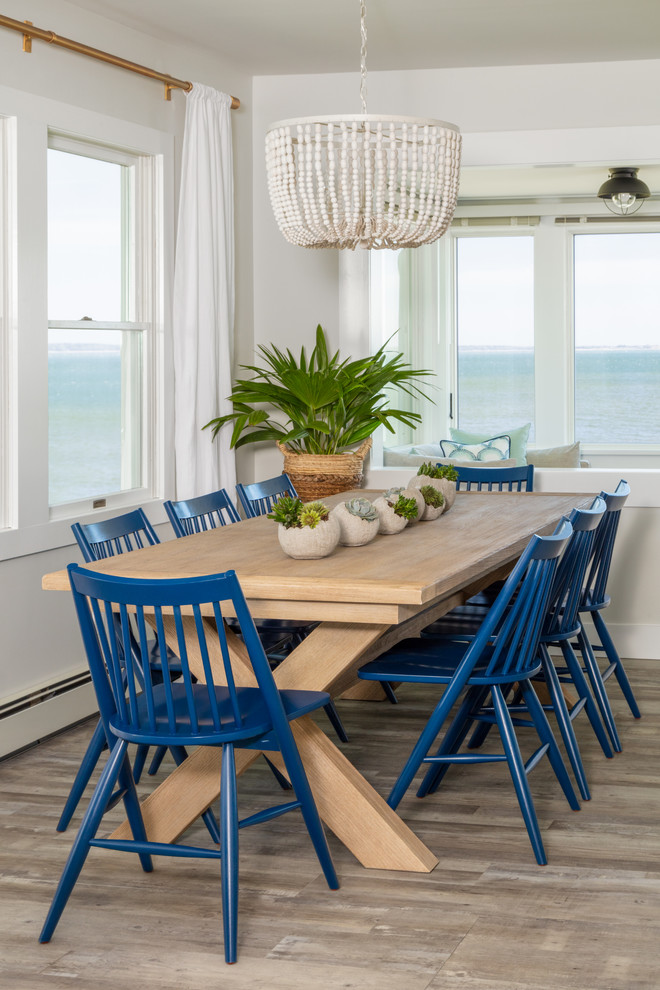 Inspiration for a beach style dining room in New York with grey walls, light hardwood floors and no fireplace.
