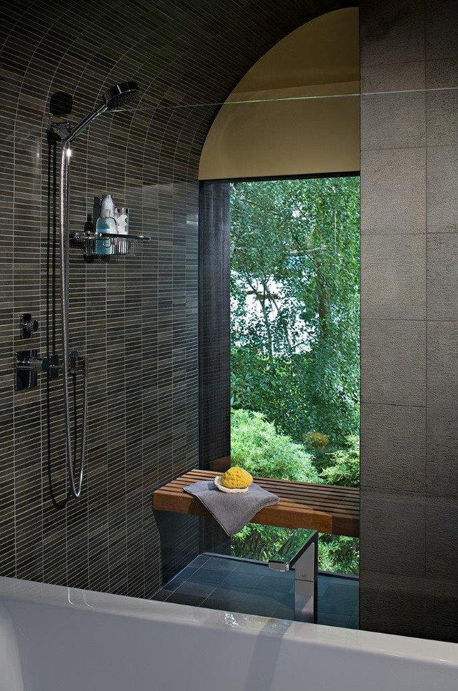 Photo of a large asian master wet room bathroom in Seattle with flat-panel cabinets, medium wood cabinets, a freestanding tub, a two-piece toilet, black tile, blue tile, gray tile, matchstick tile, yellow walls, slate floors, an undermount sink and granite benchtops.