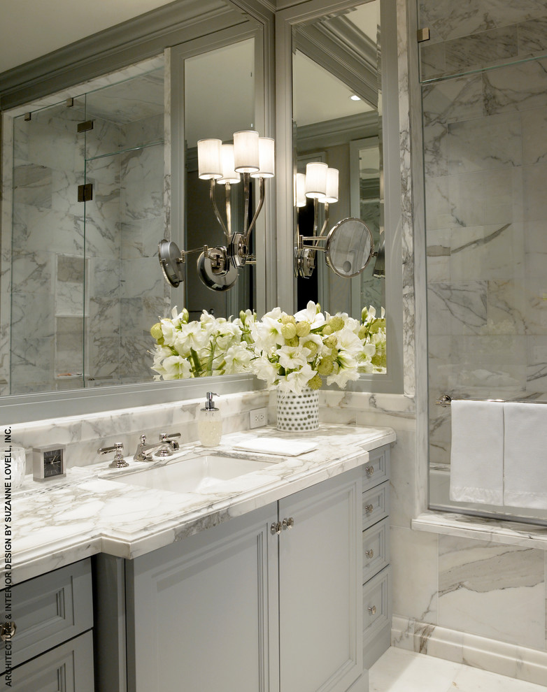 Inspiration for a contemporary bathroom in Chicago with an undermount sink, raised-panel cabinets, grey cabinets, marble benchtops, a drop-in tub and stone slab.