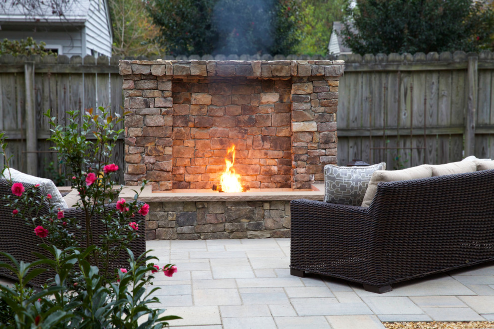 This is an example of a mid-sized arts and crafts backyard patio in Richmond with a fire feature, concrete pavers and no cover.