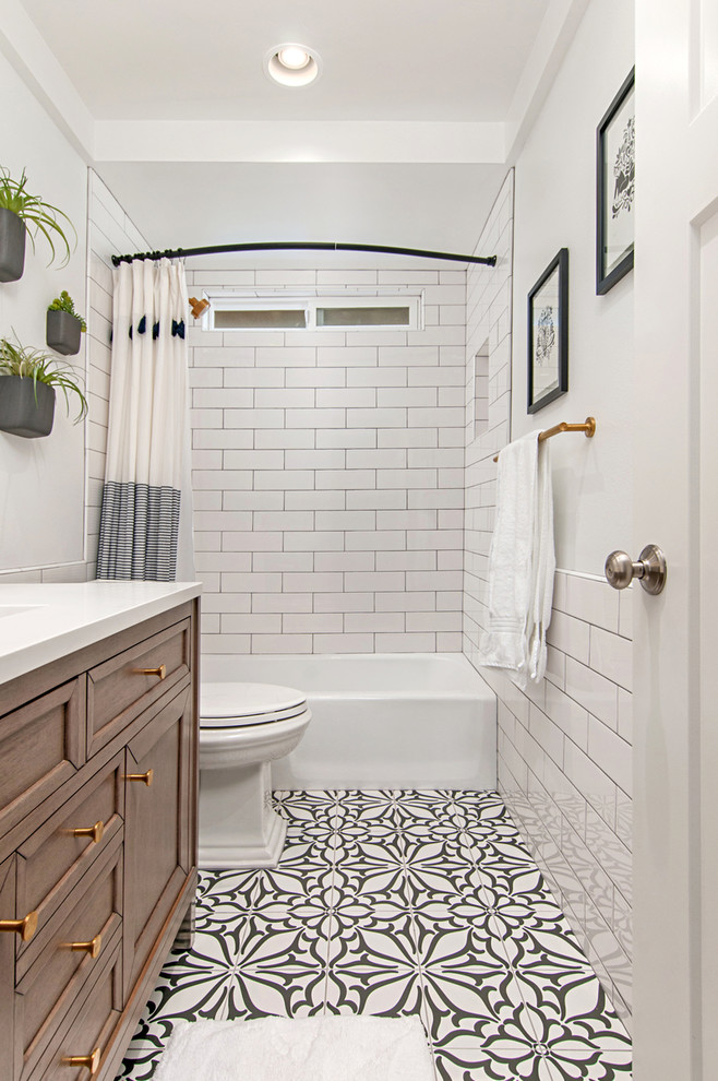 This is an example of a mid-sized modern master bathroom in San Diego with recessed-panel cabinets, white cabinets, an open shower, a two-piece toilet, white tile, subway tile, white walls, porcelain floors, a drop-in sink, grey floor, an open shower, white benchtops, engineered quartz benchtops, a single vanity and a freestanding vanity.