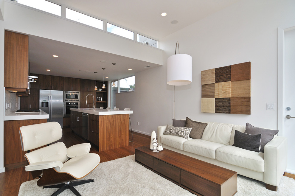 This is an example of a contemporary open concept living room in Vancouver with white walls.