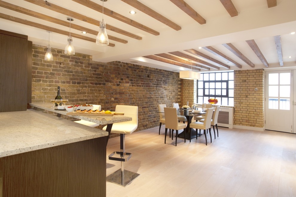 Design ideas for a large contemporary kitchen/dining combo in London with white walls, light hardwood floors and no fireplace.