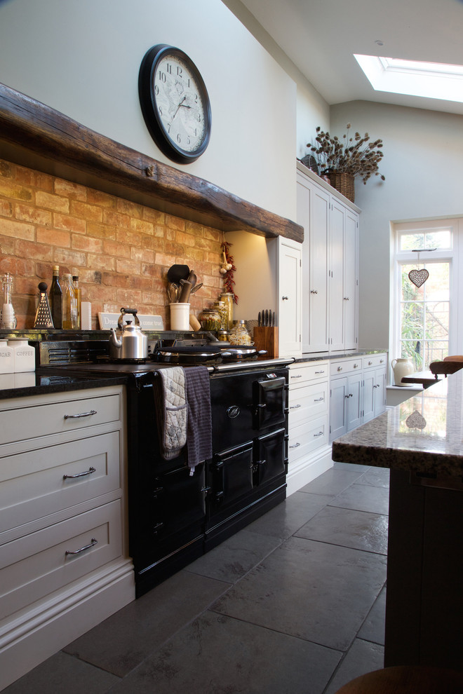 Photo of a country kitchen in Wiltshire with limestone floors.