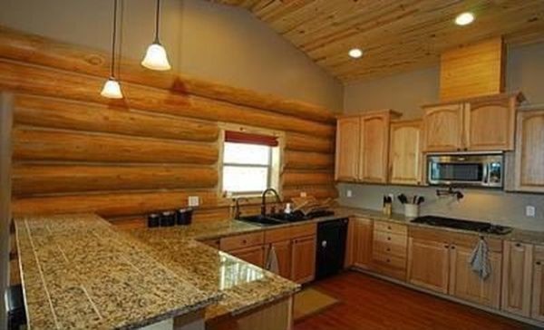 Example of a mid-sized mountain style l-shaped open concept kitchen design with recessed-panel cabinets and light wood cabinets