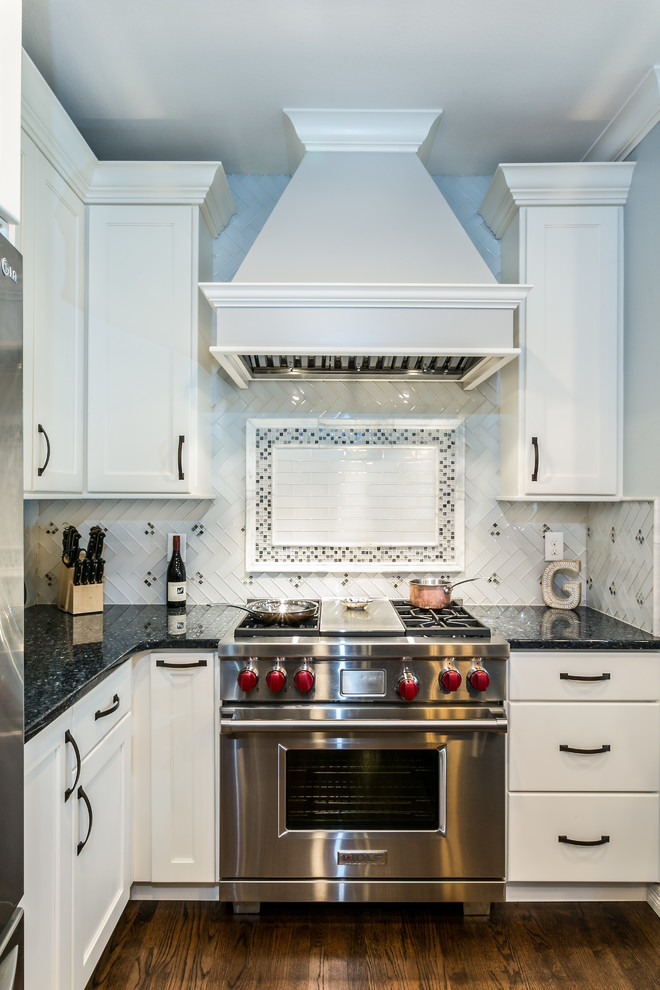 Example of a transitional brown floor kitchen design in Denver with shaker cabinets, white cabinets and stainless steel appliances