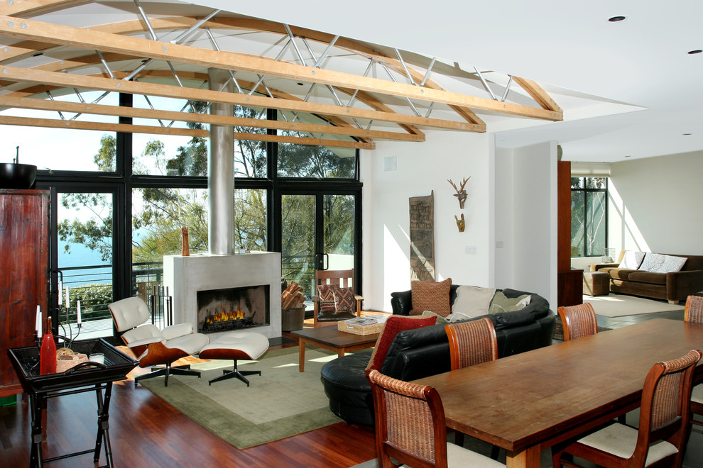 This is an example of a tropical living room in Orange County with white walls.