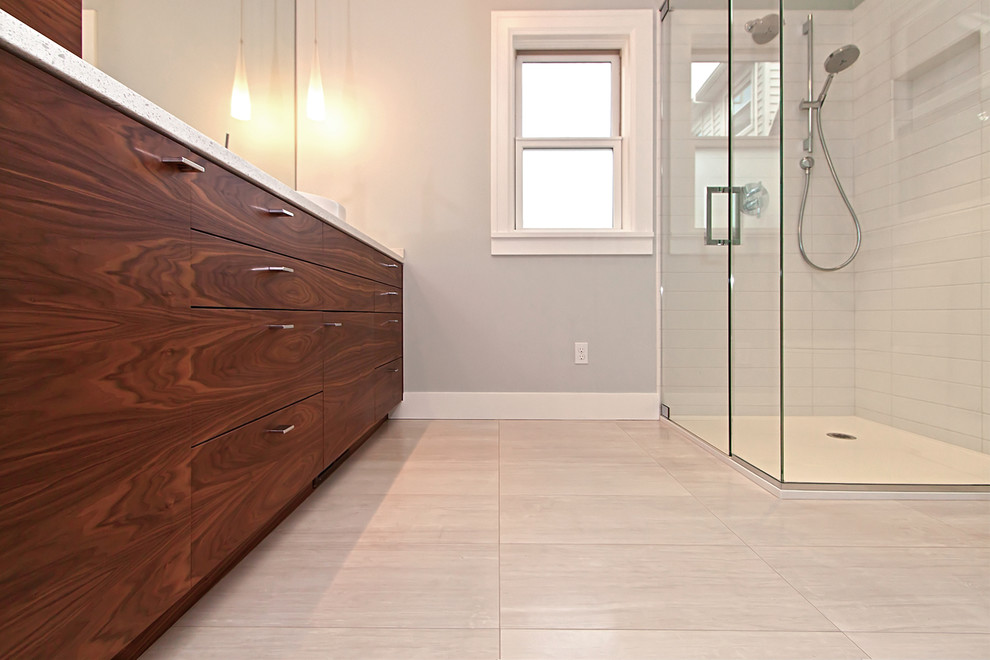 Large contemporary master bathroom in Portland with a vessel sink, flat-panel cabinets, dark wood cabinets, engineered quartz benchtops, a corner shower, white tile, ceramic tile, grey walls, ceramic floors, a two-piece toilet, beige floor and a hinged shower door.