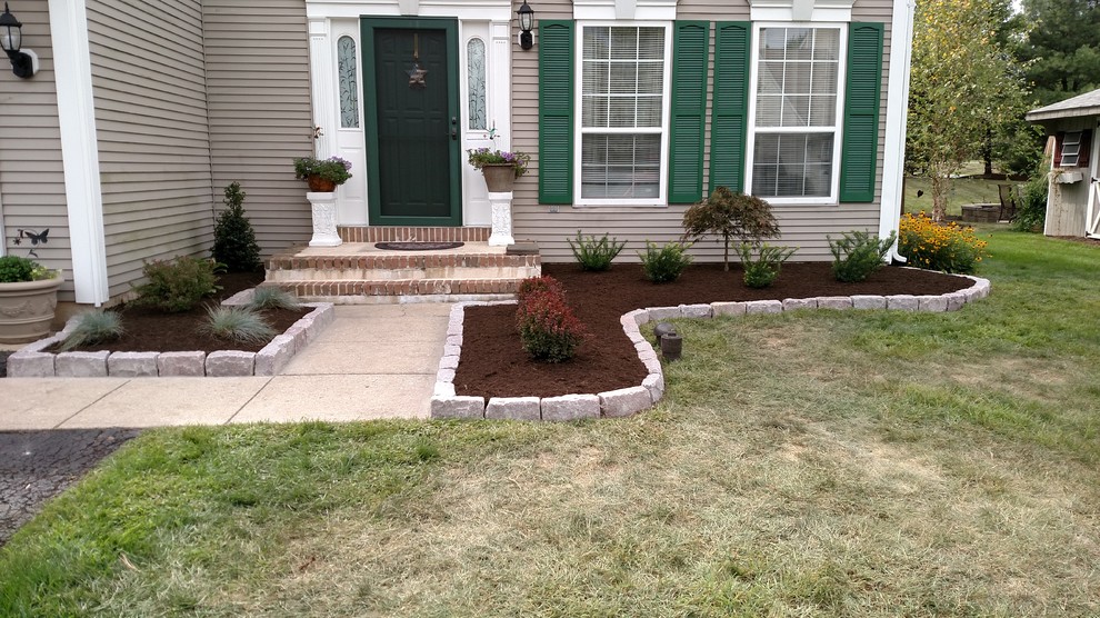 Photo of a mid-sized transitional front yard garden in Philadelphia with a garden path and concrete pavers.