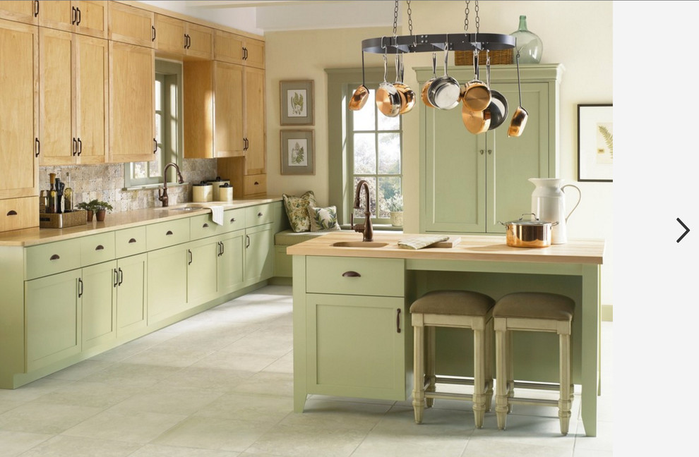 This is an example of a country single-wall eat-in kitchen in Salt Lake City with an undermount sink, shaker cabinets, green cabinets, wood benchtops, beige splashback, stone tile splashback, panelled appliances, ceramic floors, with island and grey floor.