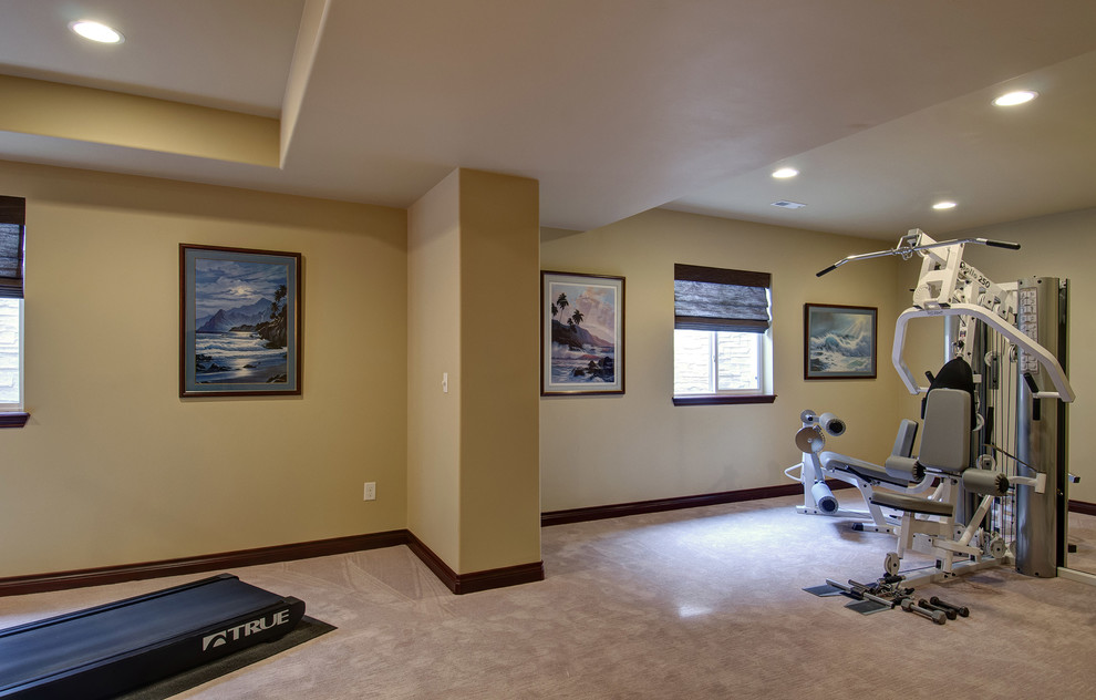 Photo of a large traditional home weight room in Denver with beige walls, carpet and beige floor.