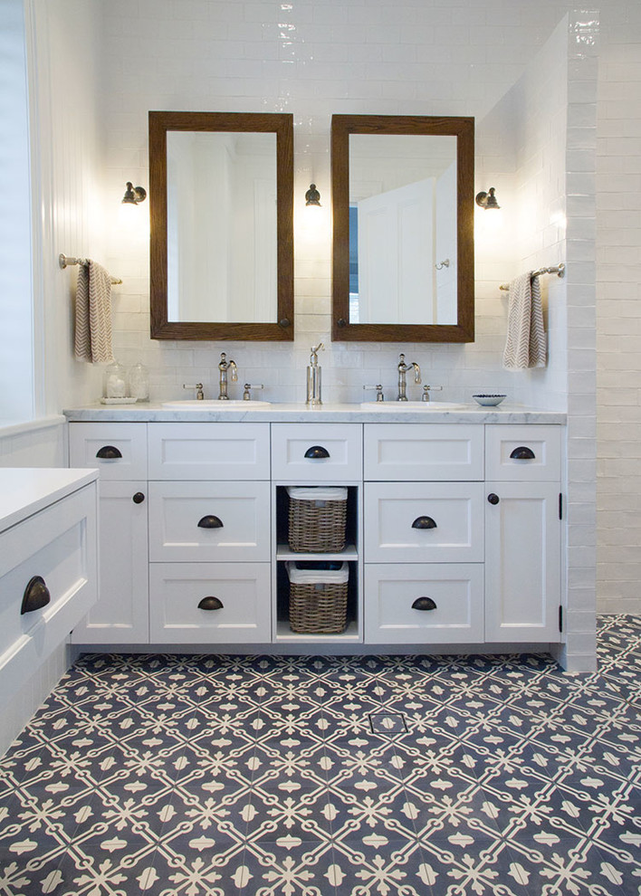 Inspiration for a large country master bathroom in Sydney with recessed-panel cabinets, white cabinets, white walls, a drop-in sink, marble benchtops, an open shower, white tile, ceramic tile and cement tiles.