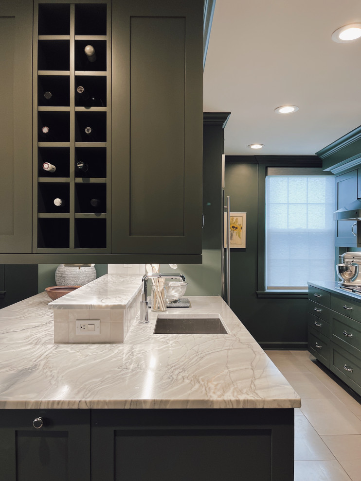 Example of a mid-sized transitional l-shaped marble floor and beige floor enclosed kitchen design with an undermount sink, shaker cabinets, green cabinets, quartzite countertops, white backsplash, ceramic backsplash, stainless steel appliances, a peninsula and gray countertops
