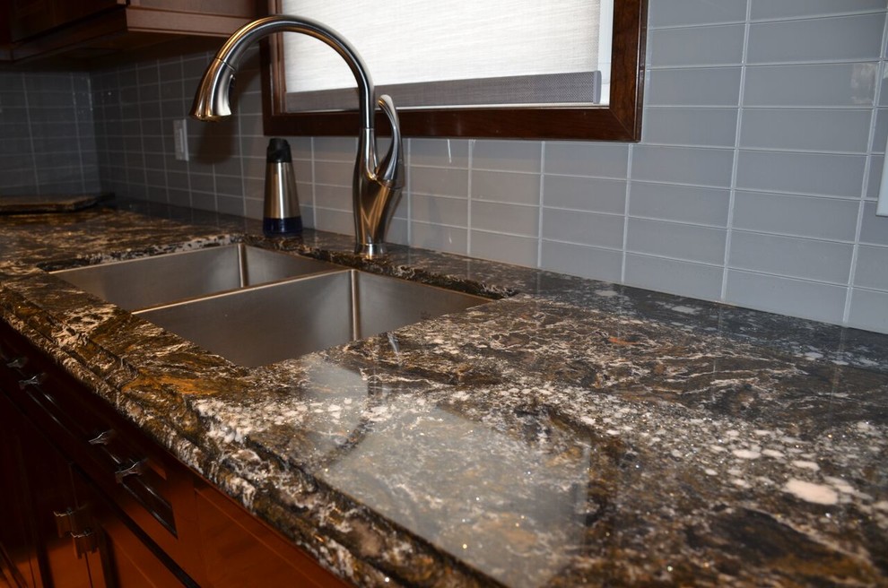 Example of a large transitional l-shaped medium tone wood floor open concept kitchen design in Toronto with an undermount sink, recessed-panel cabinets, dark wood cabinets, quartzite countertops, gray backsplash, glass tile backsplash, stainless steel appliances and an island