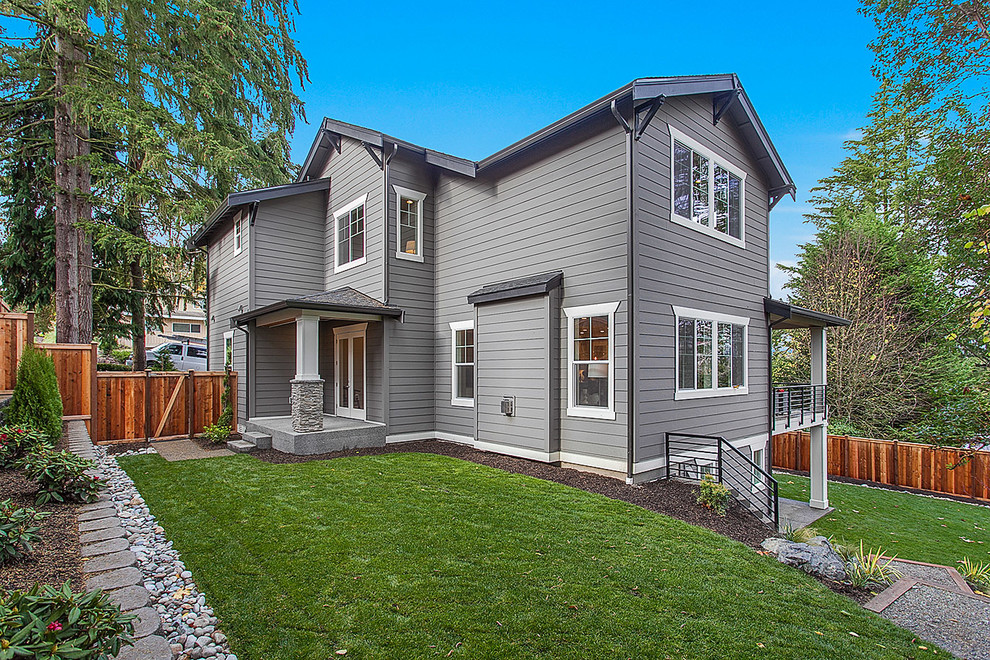 This is an example of a large arts and crafts three-storey grey exterior in Seattle with mixed siding.