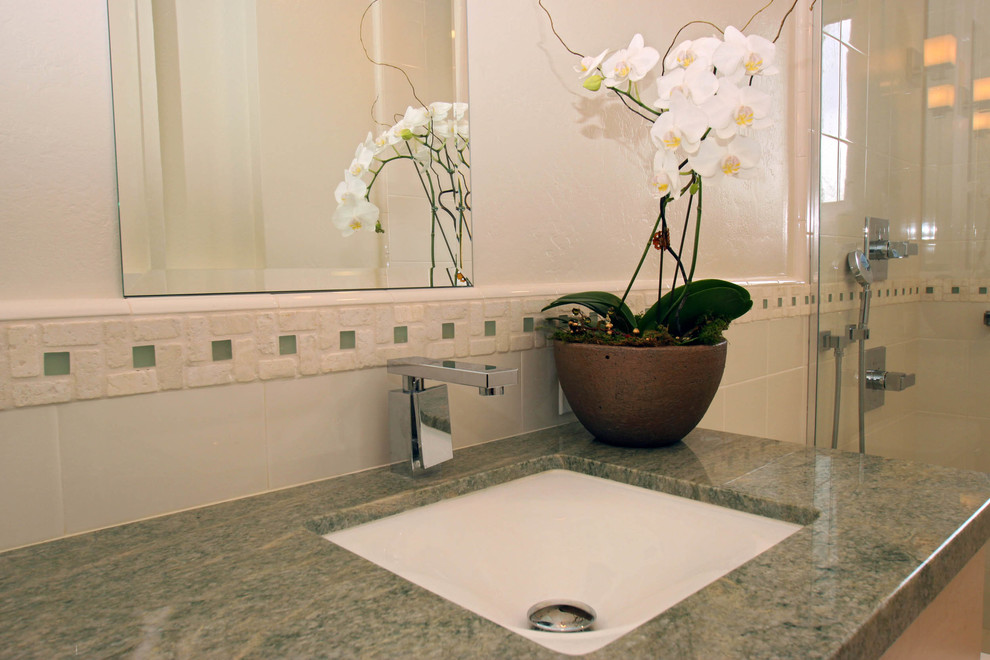 This is an example of a mid-sized traditional 3/4 bathroom in San Francisco with an undermount sink, shaker cabinets, light wood cabinets, an alcove shower, a one-piece toilet, white tile, white walls and ceramic floors.