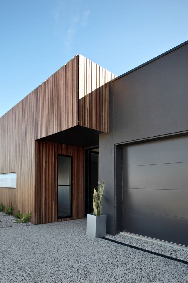 This is an example of a mid-sized industrial one-storey black exterior in Sunshine Coast with wood siding.