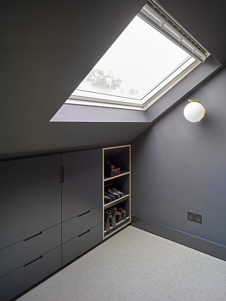 Small industrial storage and wardrobe in London with grey cabinets and grey floor.