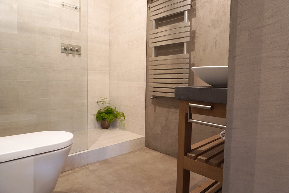 Small industrial master bathroom in London with open cabinets, grey cabinets, an open shower, beige tile, ceramic tile, grey walls, concrete floors and concrete benchtops.
