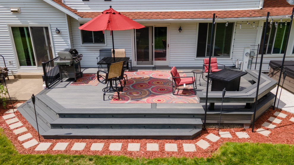 Mid-sized transitional backyard metal railing deck photo with a bbq area