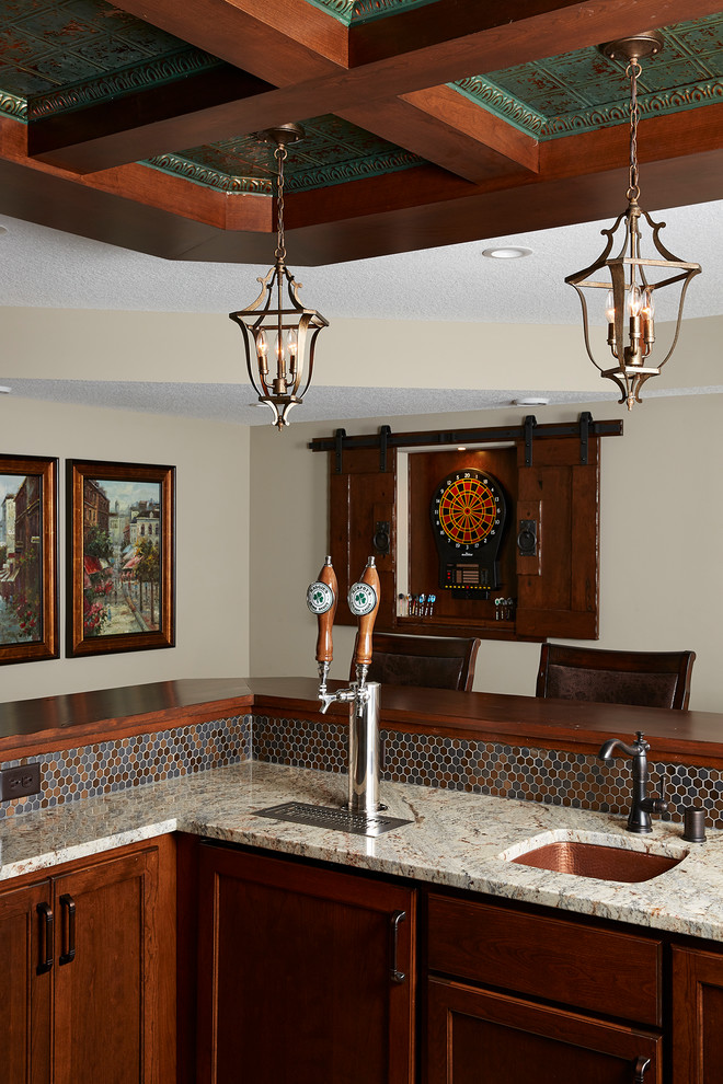 This is an example of a large traditional u-shaped wet bar in Minneapolis with an undermount sink, recessed-panel cabinets, dark wood cabinets, granite benchtops, multi-coloured splashback, ceramic splashback, vinyl floors, brown floor and beige benchtop.