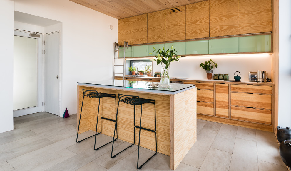 Mid-sized midcentury galley open plan kitchen in Edinburgh with light wood cabinets and with island.