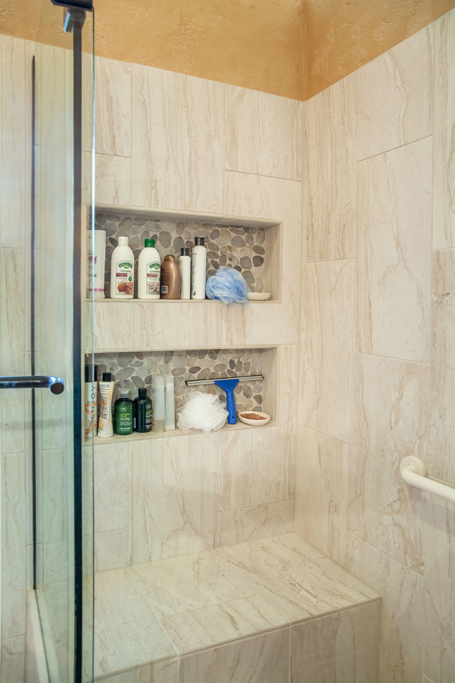 Inspiration for a master bathroom in Phoenix with beaded inset cabinets, medium wood cabinets, an alcove shower, a two-piece toilet, gray tile, pebble tile, orange walls, ceramic floors, an undermount sink and granite benchtops.