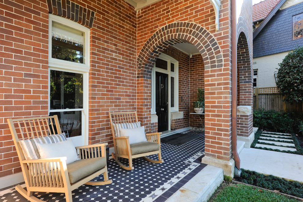 Inspiration for a traditional front yard patio in Sydney with tile and a roof extension.