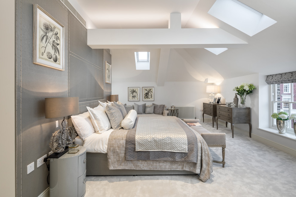 Design ideas for a mid-sized transitional master bedroom in London with white walls, carpet and grey floor.