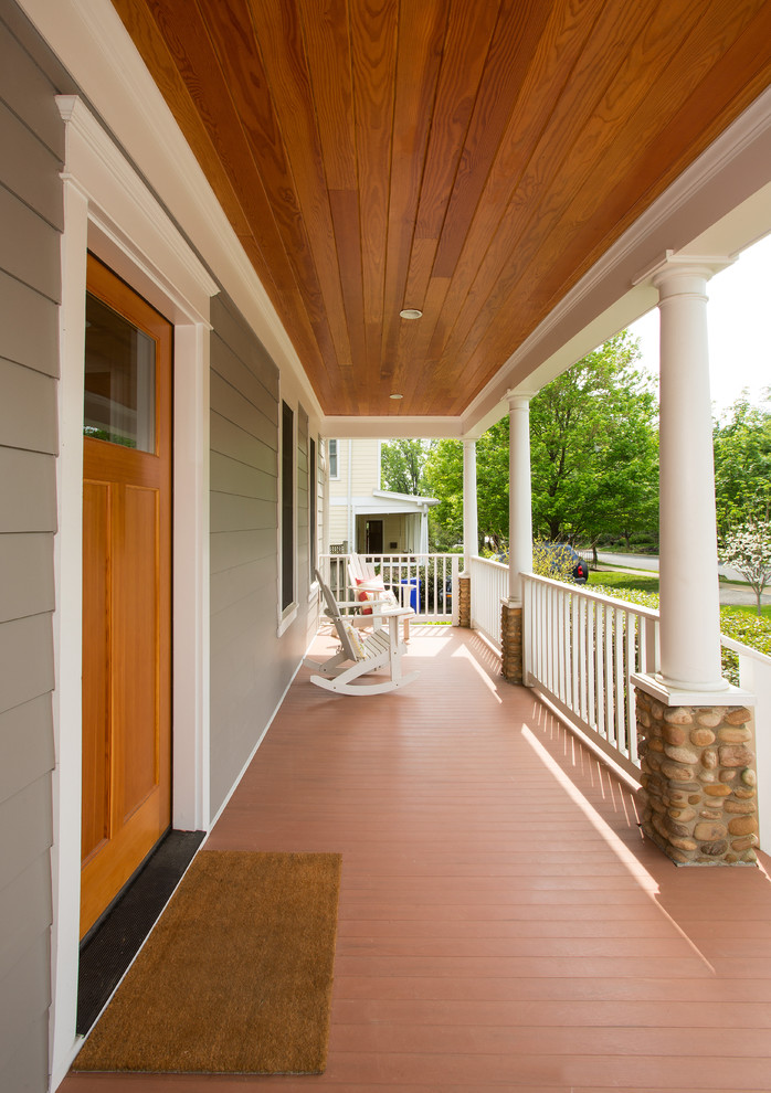 Photo of a traditional front yard verandah in DC Metro with a roof extension.