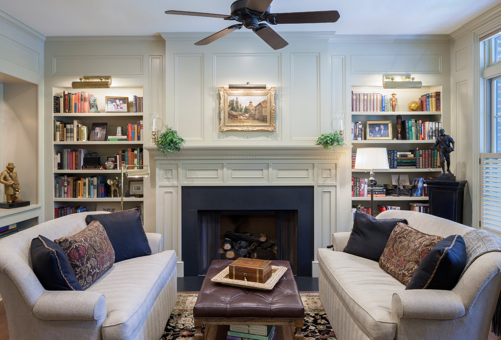 Traditional family room in Grand Rapids with a library, dark hardwood floors, a standard fireplace, a metal fireplace surround and brown floor.