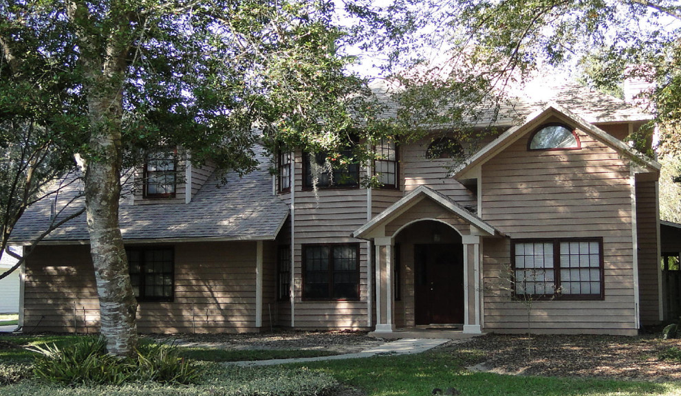 Inspiration for a mid-sized transitional beige two-story vinyl exterior home remodel in Miami
