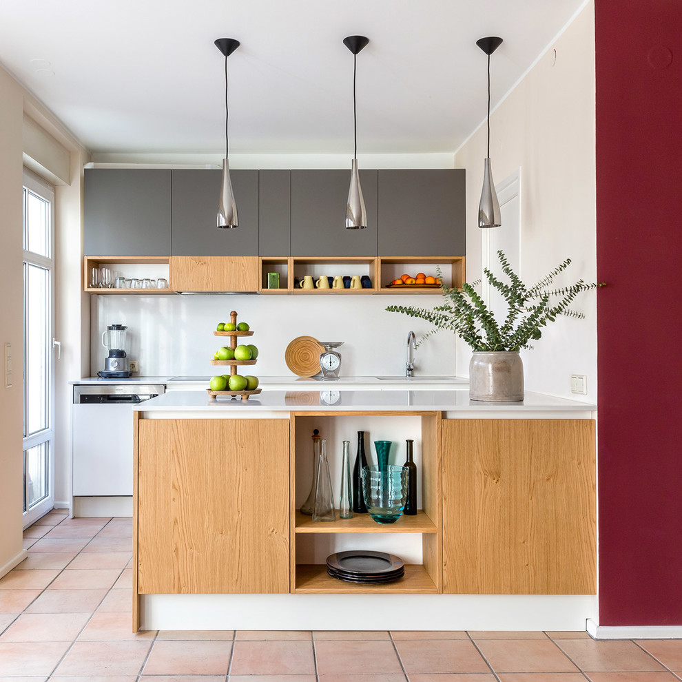 Design ideas for a mid-sized contemporary galley eat-in kitchen in Berlin with a drop-in sink, flat-panel cabinets, grey cabinets, quartz benchtops, beige splashback, stainless steel appliances, with island, pink floor and beige benchtop.