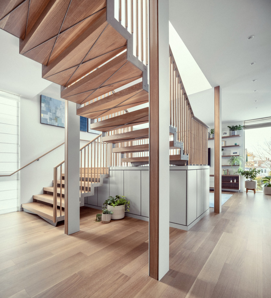 Contemporary wood floating wood railing staircase in Portland Maine with metal risers.