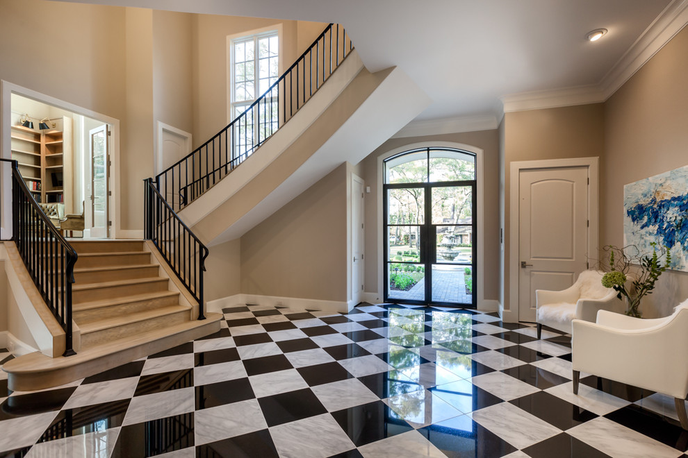 Inspiration for a large transitional porcelain tile foyer remodel in Houston with beige walls and a glass front door