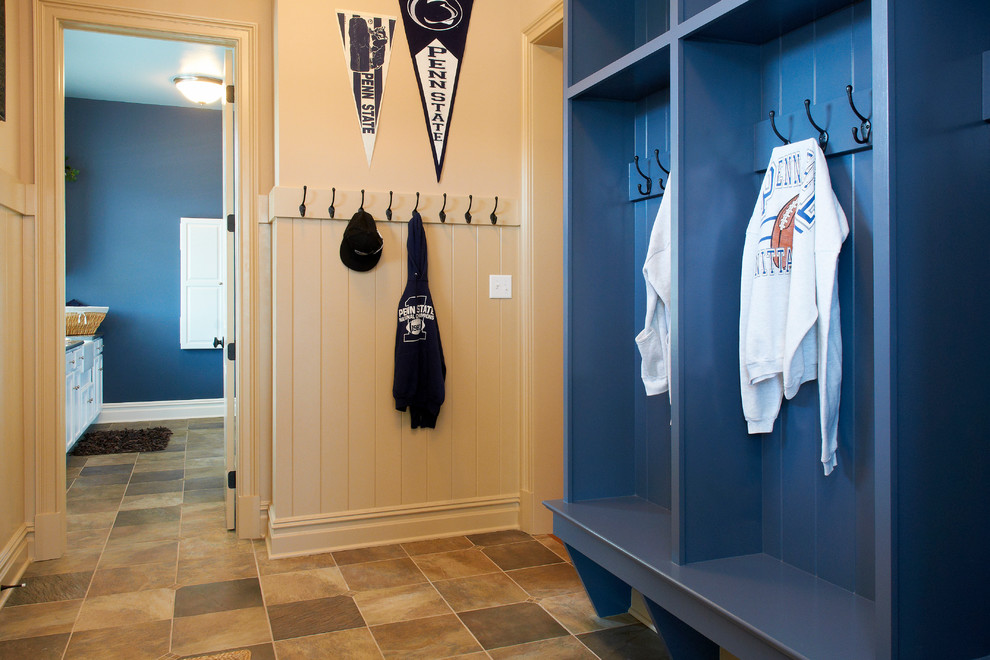 Inspiration for a mid-sized transitional mudroom in Other with white walls and slate floors.