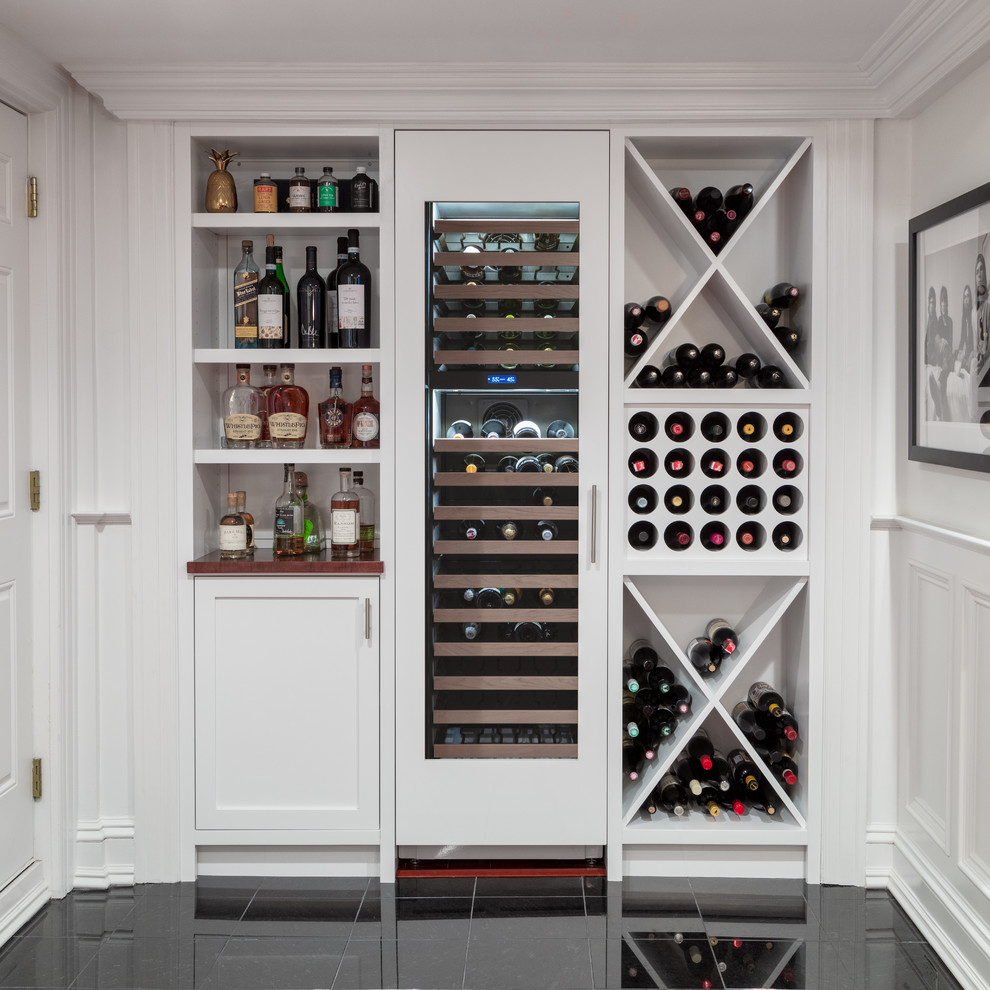 Design ideas for a country wine cellar in Boston with black floor.