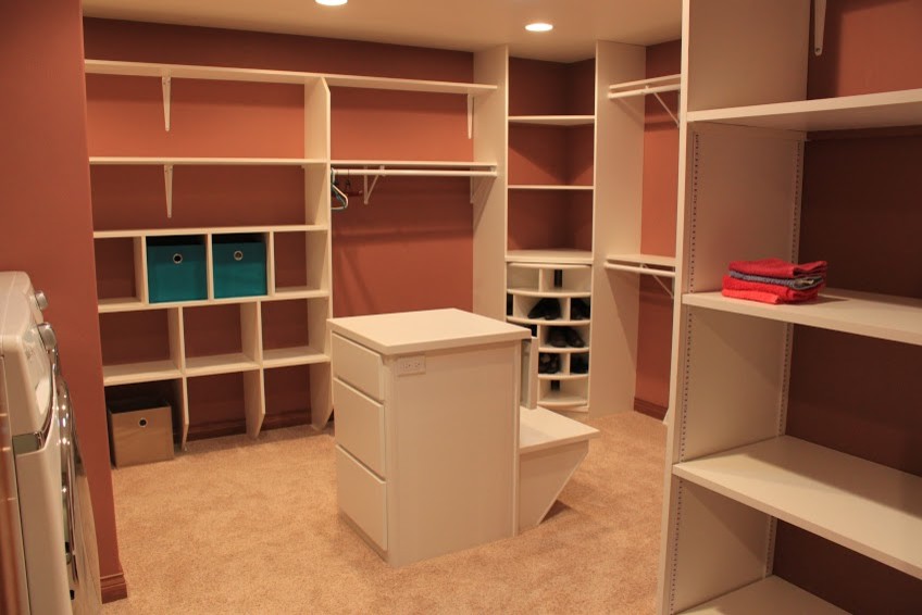 Walk-in closet - huge modern gender-neutral carpeted walk-in closet idea with flat-panel cabinets and white cabinets